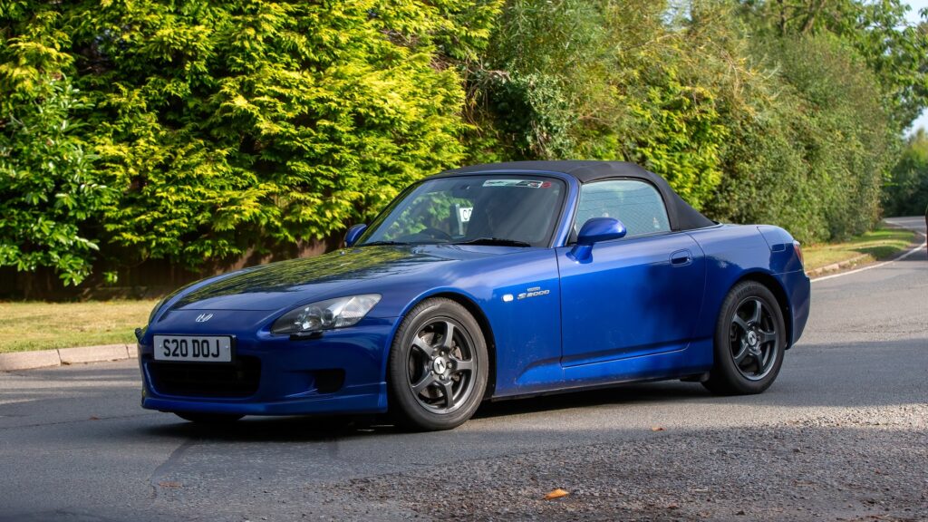 2002 blue Honda S2000 car driving on a British country road