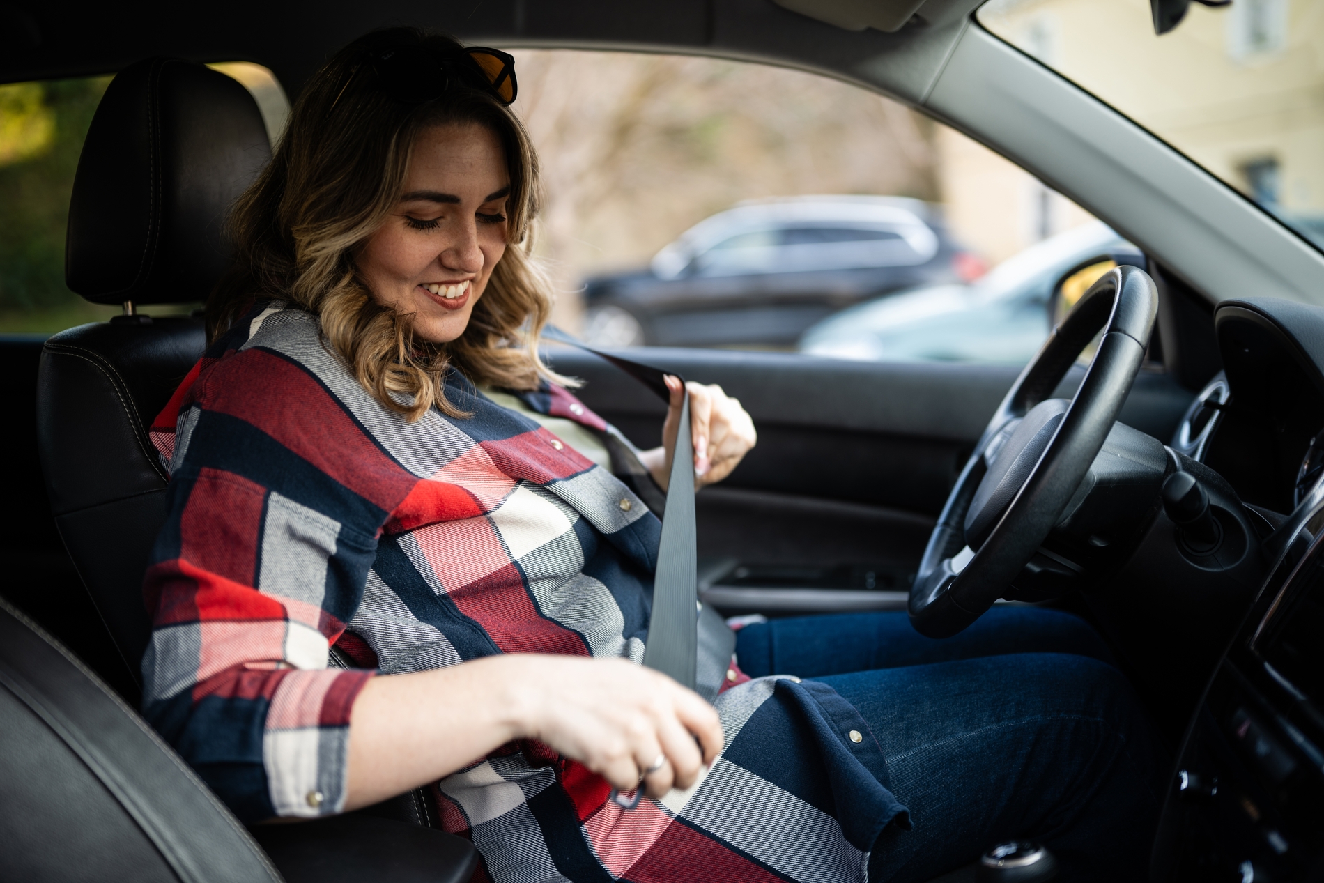 Woman Securing Her Seat Belt