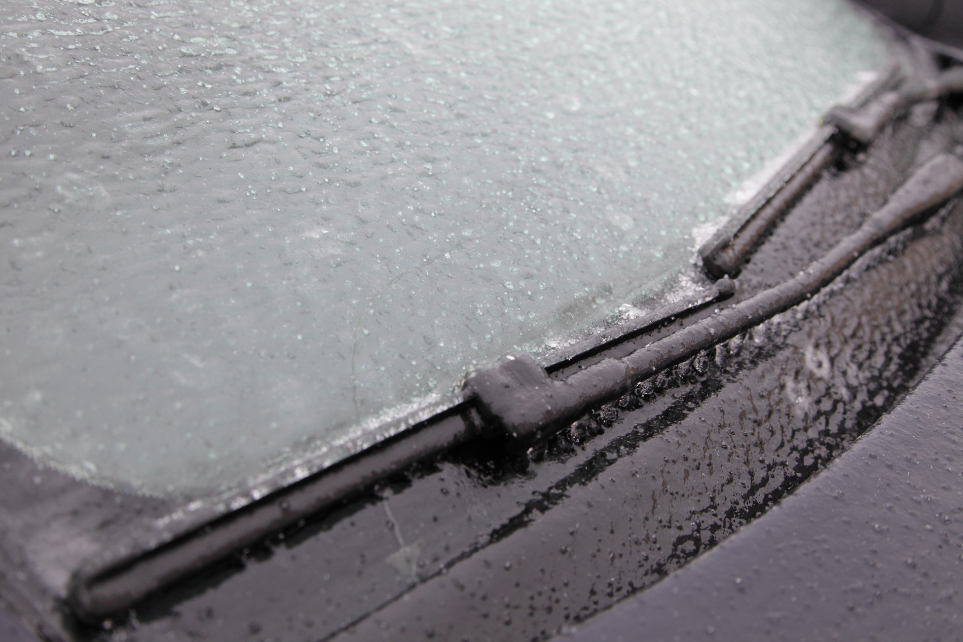 frozen windshield wiper blade close up winter car